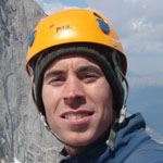 Rock climbing student practicing slab climbing technique during a guide training course.